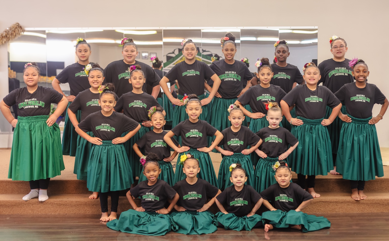 Keiki hula students in green pāʻū
